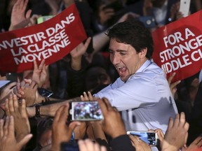 Liberal leader Justin Trudeau greets supporters during a campaign rally in Surrey, British Columbia, October 18, 2015. Canadians will go to the polls in a federal election on October 19. REUTERS/Chris Wattie