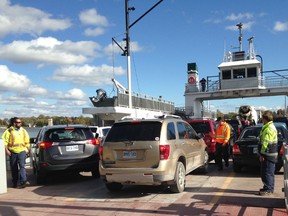 Crew members load vehicles onto the Frontenac II for the trip to Wolfe Island in Kingston on Oct. 16. (Elliot Ferguson/The Whig-Standard)