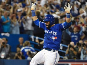 Toronto Blue Jays right fielder Jose Bautista (19) reacts after hitting a three-run home run against the Texas Rangers in the 7th inning in game five of the ALDS at Rogers Centre. Mandatory Credit: Peter Llewellyn-USA TODAY Sports