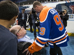 Edmonton Sun columnist Cam Tait (centre), former Oilers captain Wayne Gretzky and Tait's grandson Nicholas Davis (left) meet during an Edmonton Oilers media availability with the members of the Stanley Cup winning 83-84 Oilers at Rexall Place in Edmonton, Alta., on Wednesday, Oct. 8, 2014. Players and coaches spoke about the historic win against the New York Islanders, reminisced about the past and had a group photo taken. The 84 reunion event is set for Oct. 10, 2014. Ian Kucerak/Edmonton Sun file
