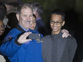 John M. Grunsfeld, left, Associate Administrator for the Science Mission Directorate, poses for a selfie with Ahmed Mohamed, 14, the Texas teenager who was arrested after bringing a homemade electronic clock to school, during the second White House Astronomy Night on the South Lawn of the White House in Washington October 19, 2015. (REUTERS/Joshua Roberts)