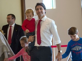 Canadian Liberal Party leader Justin Trudeau casts his ballot with his children in Montreal on October 19, 2015. The first of 65,000 polling stations opened Monday on Canada's Atlantic seaboard for legislative elections that pitted Prime Minister Stephen's Tories against liberal and social democratic parties. Up to 26.4 million electors are expected to vote in 338 electoral districts. Some 3.6 million already cast a ballot in advance voting a week ago, and the turnout Monday is expected to be high.   AFP PHOTO/NICHOLAS KAMM