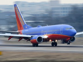 In this Feb. 3, 2014, file photo, a Southwest Airlines jet lands at Love Field in Dallas. (AP Photo/LM Otero, File)