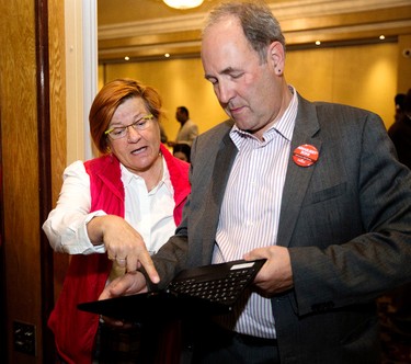 Former Liberal MLA Laurie Blakeman and Edmonton City Councillor Ben Henderson watch the election results at Edmonton - Mill Woods Liberal candidate Amarjeet Sohi's party at the Maharaja Banquet Hall, 9257 - 34A Ave., in Edmonton Alta. on Monday Oct. 18, 2015. David Bloom/Edmonton Sun/Postmedia Network