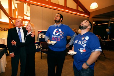 PC candidate Kerry Diotte (r) with his partner Clare Denman along with supporters Trevor Norris (r) and Ross Hamilton (c) watch as results start rolling in at Highlands Golf Course in Edmonton, Alberta on October 19, 2015. Perry Mah/Edmonton Sun/Postmedia Network