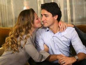 Liberal leader Justin Trudeau is kissed by his wife, Sophie Gregoire, as they watch results at his election night headquarters in Montreal, Quebec, October 19, 2015. (REUTERS/Chris Wattie)