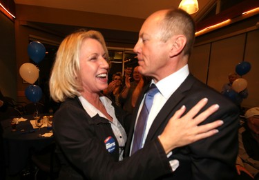 PC candidate Kerry Diotte hugs his partner Clare Denman after declared the winner of Edmonton Griesbach at Highlands Golf Course in Edmonton, Alberta on October 19, 2015. Perry Mah/Edmonton Sun/Postmedia Network