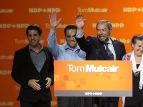 New Democratic Party leader Tom Mulcair waves with his wife Catherine and sons Greg, left, and Matthew after he gave his concession speech after the federal election in Montreal, October 19, 2015. (REUTERS/Mathieu Belanger)