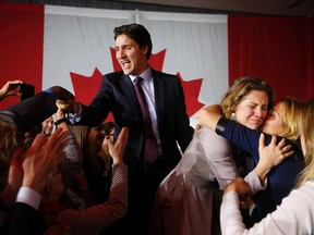 Liberal Party leader Justin Trudeau waves while accompanied by his wife Sophie Gregoire (2nd from R) as he arrives to give his victory speech after Canada's federal election in Montreal, Quebec, October 19, 2015. REUTERS/Jim Young