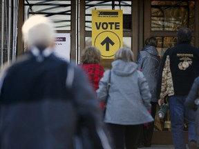 Voters enter a polling station in Quebec City, October 19, 2015. Canadians go to the polls in a federal election on Monday.  REUTERS/Mathieu Belanger