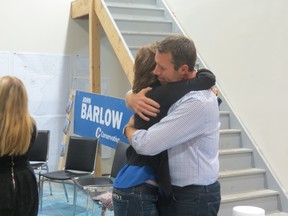 Conservative MP John Barlow hugs wife Louise after being elected for the riding of Foothills.