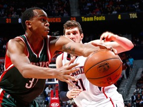 John Henson #31 of the Milwaukee Bucks drives against Mike Muscala #31 of the Atlanta Hawks at Philips Arena on March 30, 2015 in Atlanta, Georgia.  Kevin C. Cox/Getty Images/AFP