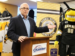 Sarnia-Lambton Chamber of Commerce board of directors chairperson Rob Taylor gestures alongside Sarnia Sting mascot Buzz at a Tuesday press conference at the Sarnia Sports and Entertainment Centre. The chamber and Sting were announcing a new loyalty rewards program for Sarnia-Lambton businesses called My Town Rewards. (Tyler Kula, Sarnia Observer)