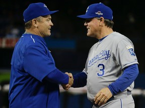 Toronto Blue Jays Manager John Gibbons meets with Kansas City Royals manager Ned Yost during Game 3 of the American League Championship Series in Toronto, Ont. on Monday October 19, 2015. Craig Robertson/Toronto Sun/Postmedia Network