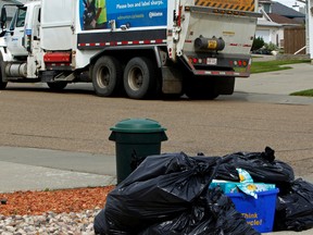 A garbage collecting truck for Edmonton's Waste Management Services works a route on Thursday Aug 6, 2015. FILE PHOTO