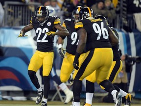 Pittsburgh Steelers cornerback William Gay (22) celebrates with defensifve end Cameron Heyward (97) and defensive tackle Cam Thomas (96) after scoring on a 28-yard interception return in the first quarter against the Tennessee Titans at LP Field.  Kirby Lee-USA TODAY Sports