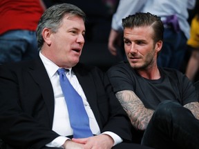Soccer star David Beckham and Tim Leiweke, President & CEO of AEG, talk as they watch the Los Angeles Lakers play the New Orleans Hornets during Game 2 of their first-round NBA Western Conference playoff game in Los Angeles on April 20, 2011. (REUTERS/Lucy Nicholson)