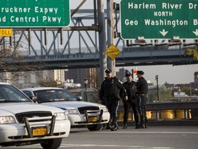 New York Police investigate the scene where the shooting of Officer Randolph Holder occurred in the Manhattan borough of New York, on  Oct. 21, 2015. Holder was shot and killed late on Tuesday while pursuing a suspected armed robber close to a busy road in the city's East Harlem neighbourhood, police said on Tuesday. (REUTERS/Andrew Kelly)