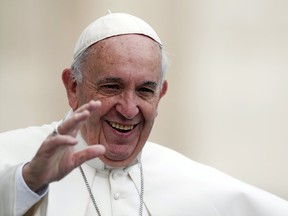 Pope Francis waves as he arrives to lead the weekly audience in Saint Peter's square at the Vatican, on Oct. 21, 2015. (REUTERS/Alessandro Bianchi)