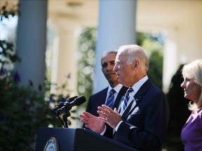 U.S. Vice President Joe Biden announces he will not seek the 2016 Democratic presidential nomination during an appearance in the Rose Garden of the White House in Washington October 21, 2015. Standing with Biden, are President Barack Obama and the vice president's wife, Dr. Jill Biden. (REUTERS/Carlos Barria)
