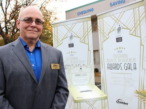 Rob Taylor with the Sarnia-Lambton Chamber of Commerce poses by new graphics for the upcoming Outstanding Business Achievement Awards. Chamber officials announced several changes Wednesday for the 27th edition of the OBAAs, coming up in May. (Tyler Kula, The Observer)