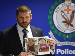 Police Det. Insp. Jason Dickinson holds up a photo of Karlie Jade Pearce-Stevenson and her daughter Khandalyce Kiara Pearce, during a press conference in Sydney, Wednesday, Oct. 21, 2015. (Dean Lewins/AAP Image via AP)