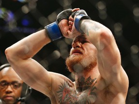 Conor McGregor celebrates after defeating Chad Mendes in their interim featherweight title mixed martial arts bout at UFC 189  in Las Vegas on July 11, 2015. (AP Photo/John Locher)