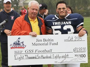 John Peter, left, a member of the Jim Boltin Memorial Committee, presents a cheque to Gananoque Trojans player Josh Leroy. The money will support the football program at Gananoque Intermediate and Secondary School.
(Postmedia Network)