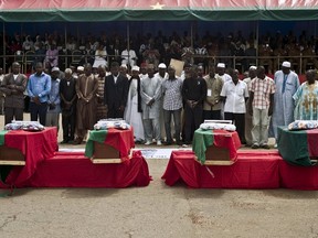 Coffins of victims of the failed military coup are lined up during an official funeral service in the Place de la Revolution in Ouagadougou, Burkina Faso, October 9, 2015. (REUTERS/Arnaud Brunet)