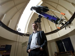 Western University physics and astronomy professor Jan Cami stands beneath the original telescope that was installed in 1940 inside The Hume Cronyn Memorial Observatory in London. (CRAIG GLOVER, The London Free Press)