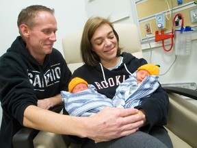 Emily Black holds three-day-old twins Jackson and Miles as partner Wesley Hetherington sits with them in the London Health Sciences Centre on Tuesday. Craig Glover/The London Free Press/Postmedia Network