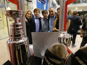 Paul Coffey with girlfriend Stephanie, sons Blake and Christian and daughter Savannah look at his display at the press conference for the induction of the Canadian Sports Hall of Fame Class of 2015 held at the Mattamy Athletic Centre in Toronto on Wednesday October 21, 2015. (Michael Peake/Toronto Sun)
