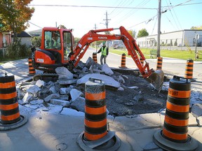 A crew from Dig N Dirt remove a roundabout from the corner of Fraser and Patrick Streets in Kingston on Friday. (Ian MacAlpine /The Whig-Standard)
