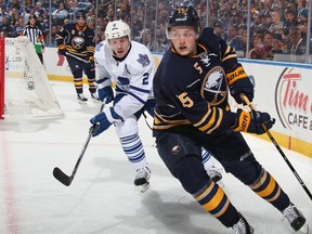 Matt Hunwick #2 of the Toronto Maple Leafs defends against Jack Eichel #15 of the Buffalo Sabres at First Niagara Center on October 21, 2015 in Buffalo, New York.   Jen Fuller/Getty Images/AFP