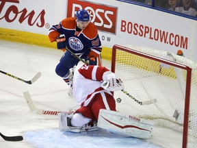 Edmonton Oilers' Connor McDavid (97) looks for the loose puck near Detroit Red Wings' goalie Petr Mrazek (34)  during first period NHL action at Rexall Place in Edmonton, Alberta on October 21, 2015. Perry Mah/Edmonton Sun/Postmedia Network