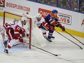 Connor McDavid evades Red Wings defenderas as he circles behind the Detroit net during the third period of Wednesday's game at Rexall Place. (Perry Mah, Edmonton Sun)