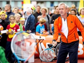 Dutch soccer legend Johan Cruyff plays tennis during the annual Open Day of the Johan Cruyff Foundation at the Olympic Stadium in Amsterdam, on September 10, 2014. During this event, children with and without handicaps and disabilities have the opportunity to do sports at various venues. AFP PHOTO/ANP KOEN VAN WEEL netherlands out