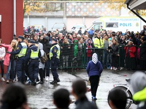 Police officers stand guard at a cordoned area after a masked man attacked people with a sword at a school in Trollhattan, western Sweden Oct. 22, 2015.  REUTERS/Bjorn Larsson Rosvall/TT News Agency