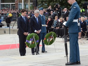 Prime Minister Stephen Harper, left, and Justin Trudeau, prime minister-designate of Canada, attend a ceremonial service on Parliament Hill in Ottawa on Thursday, Oct. 22, 2015 to commemorate the attack on and the lives of Corporal Nathan Cirillo and Warrant Officer Patrice Vincent. THE CANADIAN PRESS/Adrian WyldKilpatrick