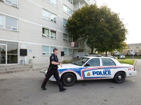 A police officer walks to his cruiser after responding to a stabbing at 114 Arbour Glen Crescent just after 9 a.m. on Thursday October 22, 2015. A six-year-old child is in serious condition, and an adult known to the child is in custody, according to police. (CRAIG GLOVER, The London Free Press)