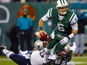 Jets QB Mark Sanchez is sacked by Patriots' Justin Francis during NFL action in East Rutherford, N.J., on Nov. 22, 2012. Sanchez will be remembered the play known as the "butt fumble" after crashing into his lineman and losing the ball, which the Patriots returned for a touchdown. (Rich Schultz /Getty Images/AFP/Files)