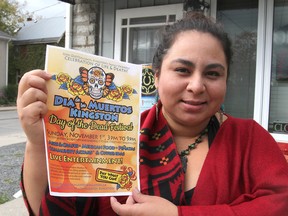 Artist/musician Yessica Rivera Belsham holds a poster promoting the Mexican holiday Dia de los Muertos - Day of the Dead - which she is inviting Kingstonians to celebrate Nov. 1. (Michael Lea/The Whig-Standard)