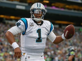 Quarterback Cam Newton #1 of the Carolina Panthers celebrates after scoring a touchdown against the Seattle Seahawks in the first half at CenturyLink Field on October 18, 2015 in Seattle, Washington. The Panthers defeated the Seahawks 27-23.   Otto Greule Jr/Getty Images/AFP