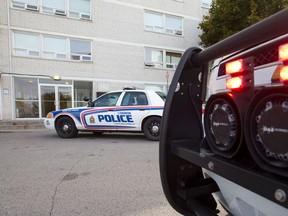 A police cruiser and EMS SUV are seen parked outside of 114 Arbour Glen Cr. in London, Ont., where emergency crews responded to reports of a stabbing just after 9 a.m. Thursday Oct. 22, 2015. (Craig Glover/The London Free Press/Postmedia Network)