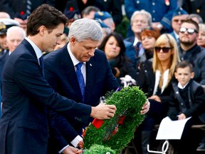 Prime Minister Stephen Harper and prime minister-designate Justin Trudeau place a wreath during a ceremony marking the one-year anniversary of the attack on Parliament Hill Thursday Oct. 22, 2015 at the National War Memorial in Ottawa. (Errol McGihon/Ottawa Sun)