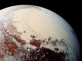 This NASA image captured by NASA's New Horizons spacecraft released October 15, 2015 shows combined blue, red and infrared images taken by the Ralph/Multispectral Visual Imaging Camera (MVIC). (AFP PHOTO/JHUAPL/SWRI)