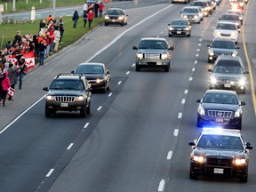 The procession carrying the body of Cpl. Nathan Cirillo, advances along the Highway of Heroes, on route to Hamilton, on Friday, Oct. 24, 2014. Cpl. Nathan Cirillo, 24, was shot while he was a honorary guard at the National War Memorial in Ottawa. Veronica Henri/Toronto Sun/Postmedia Network
