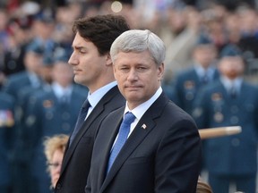 Prime minister-designate Justin Trudeau and Prime Minister Stephen Harper stand before placing a wreath during a ceremony marking the one year anniversary of the attack on Parliament Hill Thursday, Oct. 22, 2015 at the National War Memorial in Ottawa. THE CANADIAN PRESS/Sean Kilpatrick