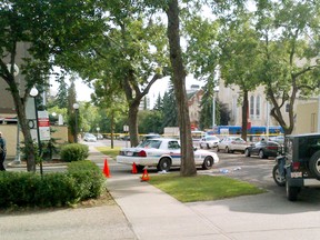 Police investigate the scene of the shooting death of 33-year-old Dale Maloney, on August 13, 2012 on 113 St., just north of Jasper Ave in Edmonton Alta.  23-year-old  Christian Iyamuremye has been charged with second-degree murder and 27-year-old Bicco Said, is wanted on a Canada-wide warrant for second-degree murder in the homicide. CODIE MCLACHLAN/EDMONTON SUN