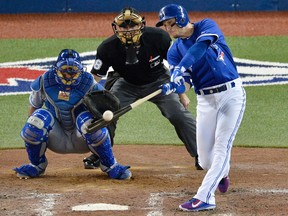 Toronto Blue Jays' Troy Tulowitzki hits a three-run RBI double off Kansas City Royals pitcher Kelvin Herrera during Game 5 of the ALCS at Rogers Centre in Toronto on Oct. 21, 2015. (THE CANADIAN PRESS/Chris Young)